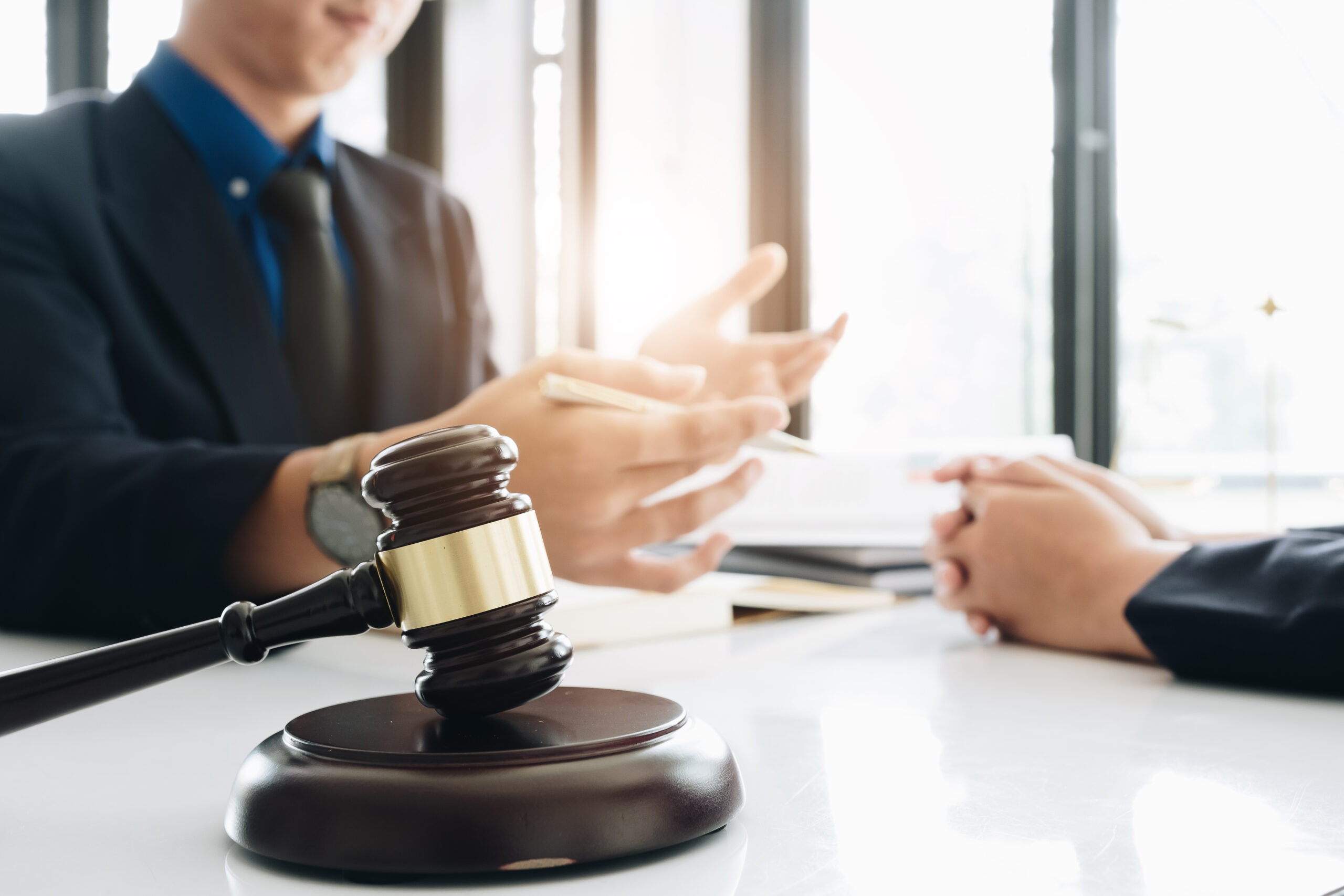 Business lawyer working about legal legislation in courtroom to help their customer, Selective Focus