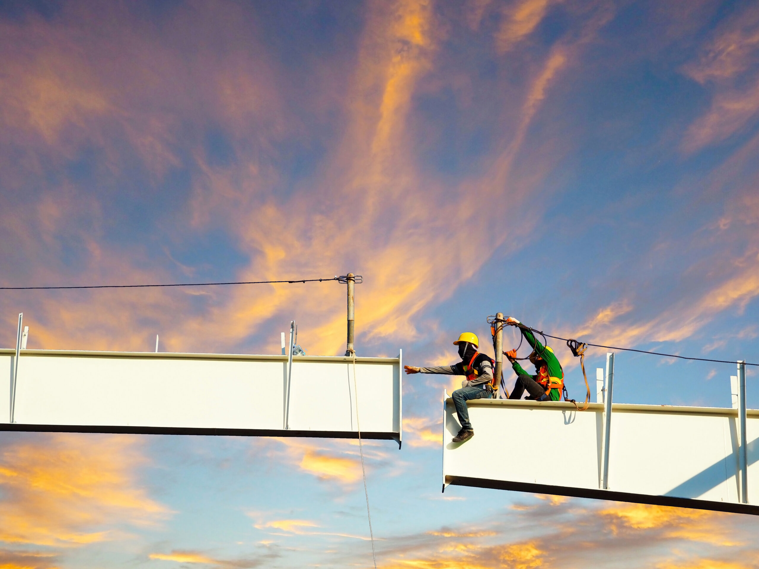 workers on a high beam