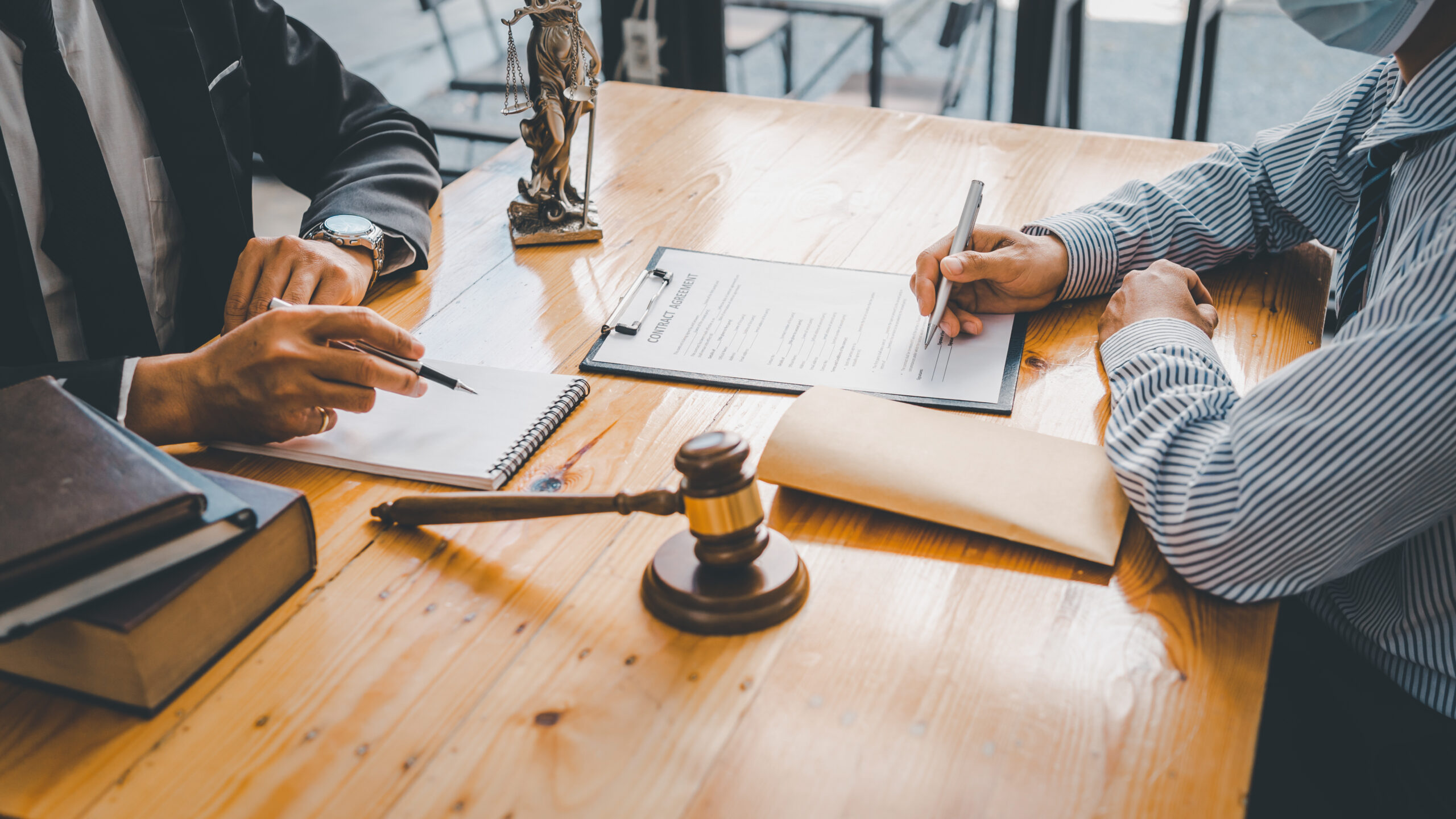 Close-up of a judge with a hammer against the background of professional lawyer talking about a lawsuit. professional lawyers discussing legal case.
