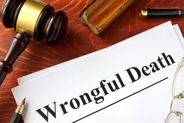 A wooden gavel rests on a desk next to a piece of paper with the words 