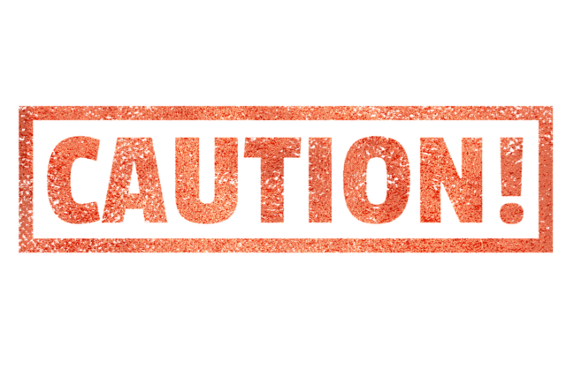 A red and orange textured sign featuring the word "CAUTION!" in bold, capital letters, enclosed within a rectangular border, serves as a stark reminder of product liability.