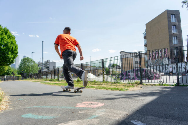 Young man skateboarding on footpath