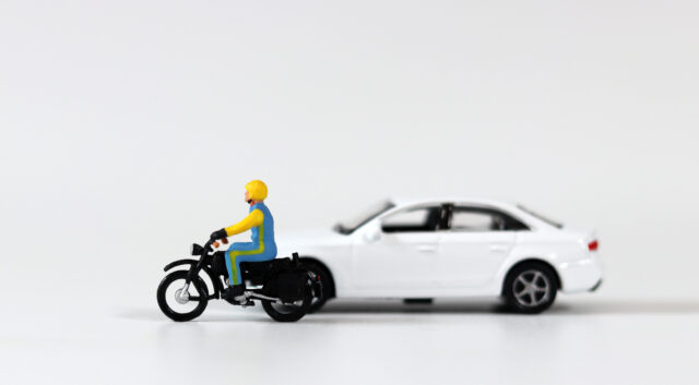 motorcycle car toy figures accident concept