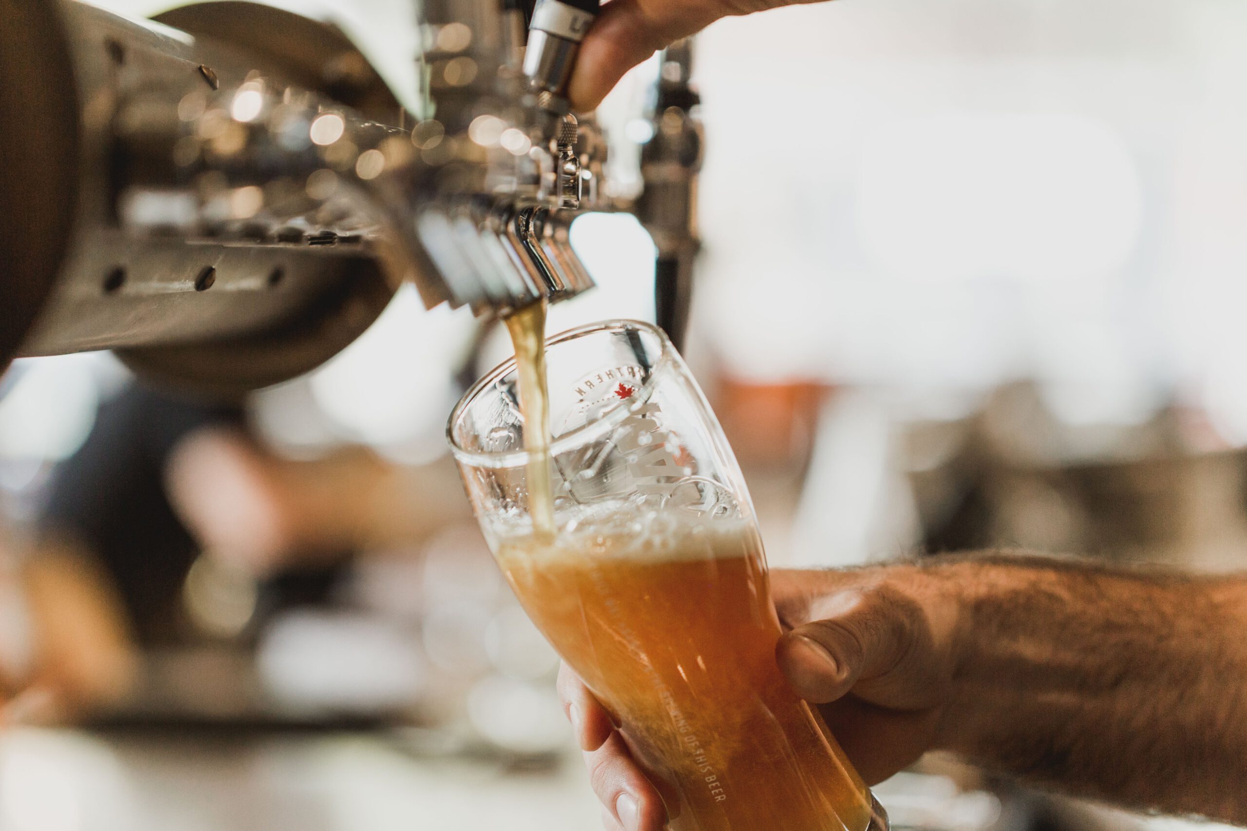 beer being poured from a tap in a bar
